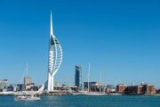 A view of Spinnaker Tower from across the Solent with a boat in view.