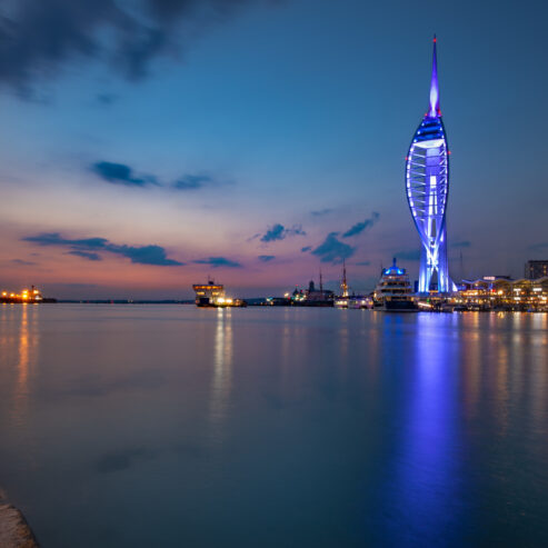 Evening shot of Spinnaker Tower lit blue