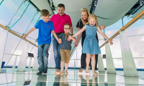 Family walking over the glass floor Sky Walk at Spinnaker Tower