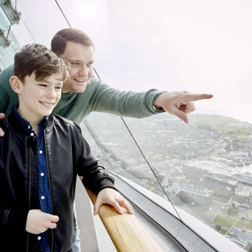 Father and son pointing to the view from the viewing deck at Spinnaker Tower Portsmouth