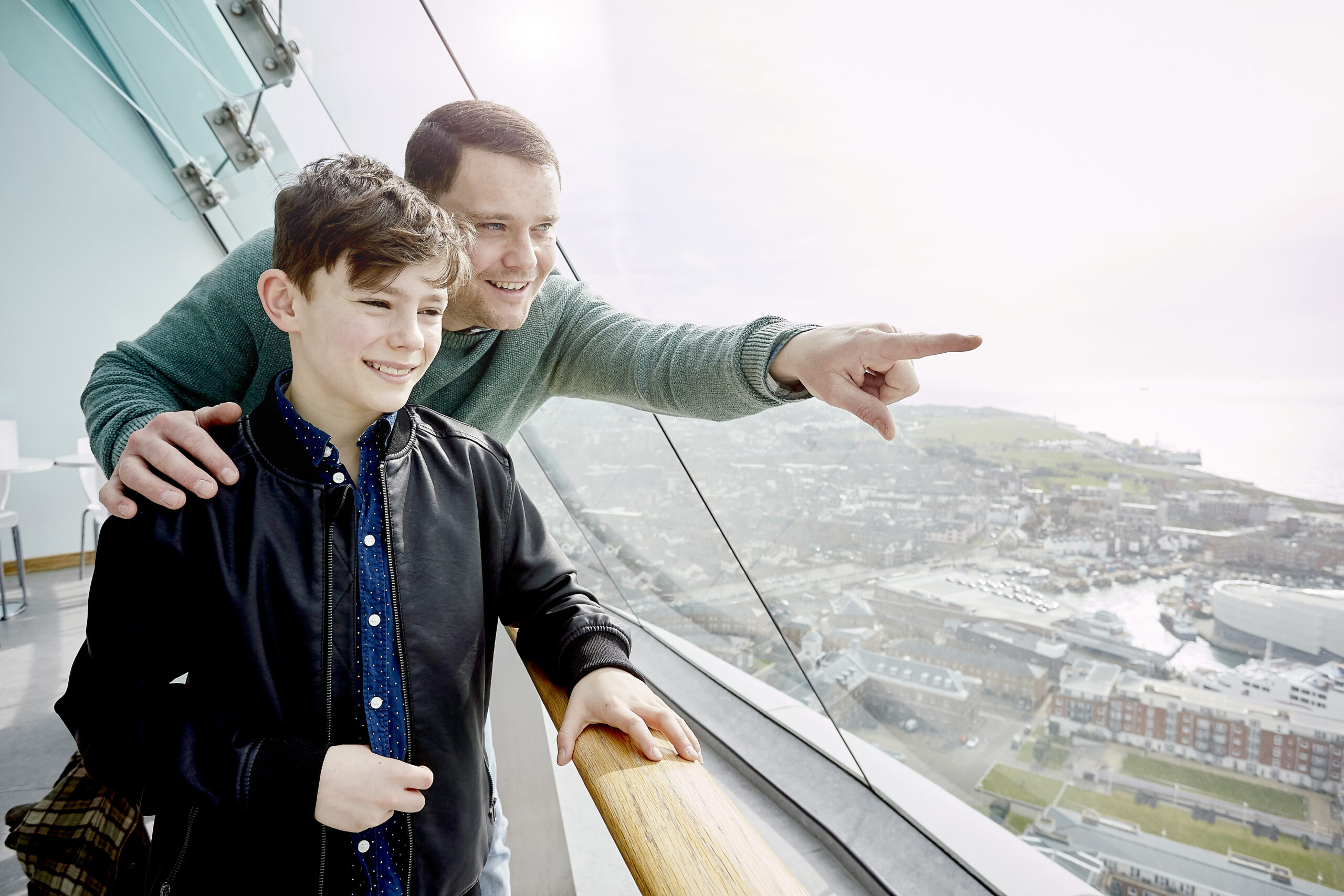 Father and son pointing to the view from the viewing deck at Spinnaker Tower Portsmouth