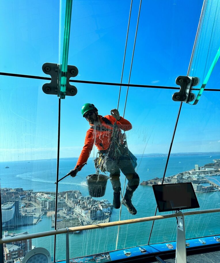 Abseiler cleaning the windows at Spinnaker Tower 110 metres up!