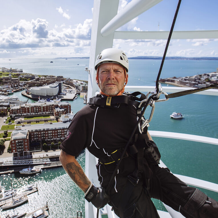 man decending 100m down the spinnaker tower as part of the iconic abseil challenge experience